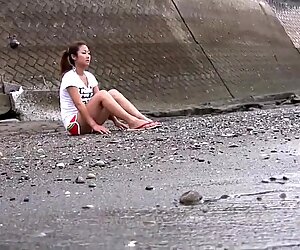 Pretty young brunette takes a walk on the beach